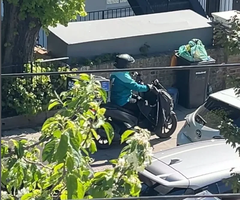 Moped delivery rider using the pavement on Greenwood Road